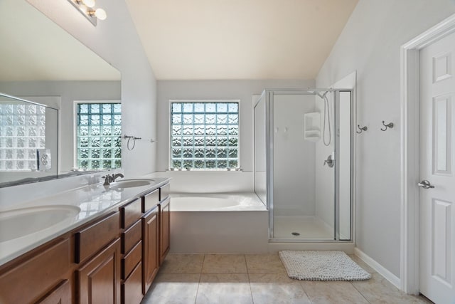 bathroom with tile patterned flooring, shower with separate bathtub, vanity, and vaulted ceiling