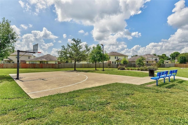 view of basketball court with a yard