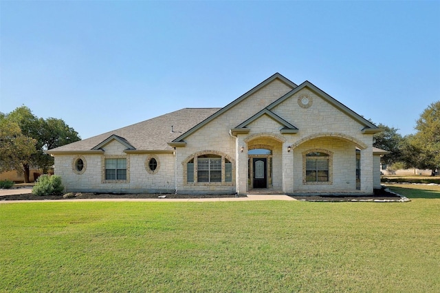 french country inspired facade with a front lawn