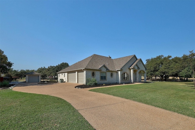 french country inspired facade featuring a front yard and a garage