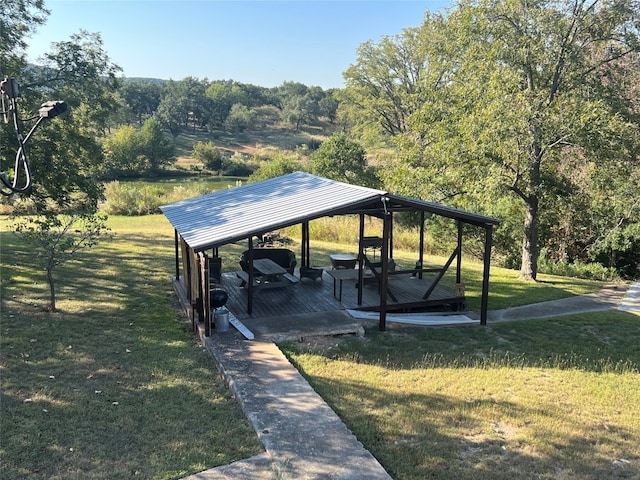 view of property's community featuring a gazebo, a wooden deck, and a lawn