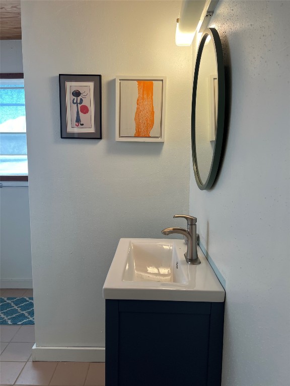 bathroom with tile patterned floors and vanity