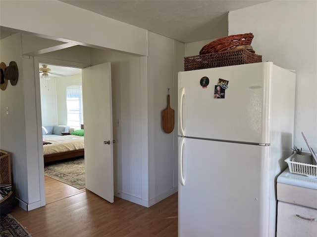 kitchen featuring ceiling fan, white fridge, and hardwood / wood-style flooring