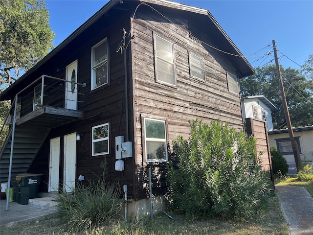 view of side of property with a balcony