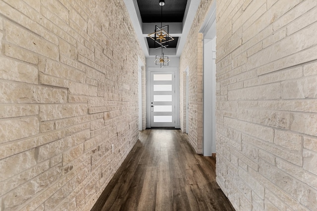 hallway with a chandelier and dark hardwood / wood-style flooring