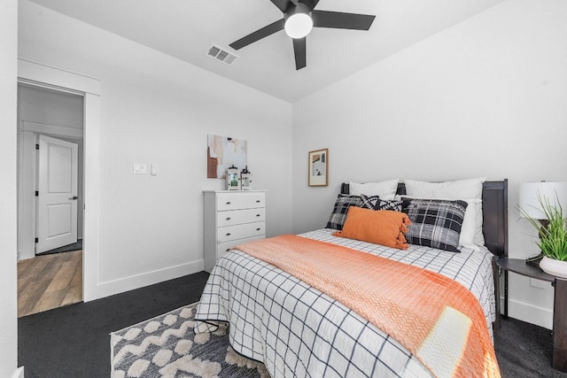 bedroom featuring ceiling fan, vaulted ceiling, and dark hardwood / wood-style flooring