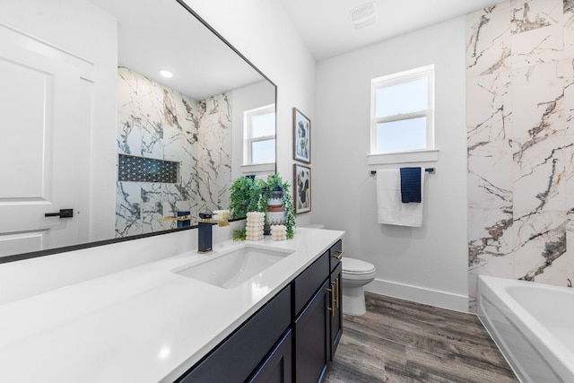 bathroom featuring vanity, toilet, and hardwood / wood-style flooring