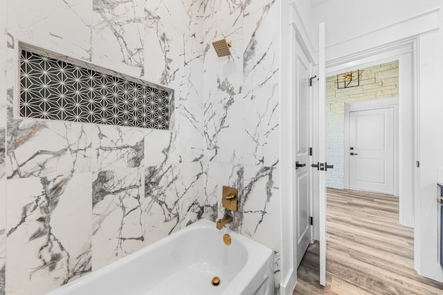 bathroom with shower / bath combination, hardwood / wood-style floors, and tile walls