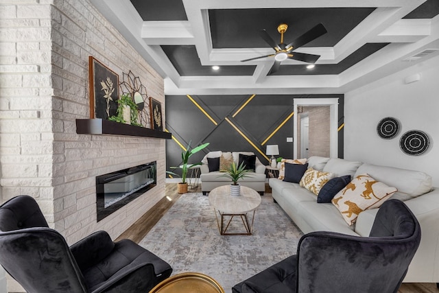 living room featuring coffered ceiling, hardwood / wood-style flooring, and crown molding