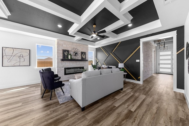 living room featuring beamed ceiling, coffered ceiling, a fireplace, and wood-type flooring