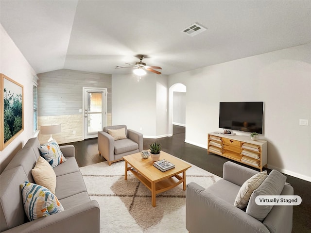 living room featuring ceiling fan, vaulted ceiling, and wood-type flooring