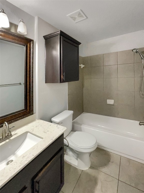 full bathroom with vanity, tiled shower / bath combo, and toilet