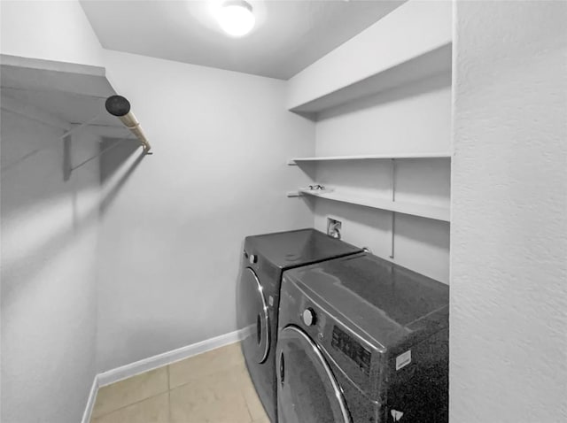 305 Rock Mill Loop, Georgetown, TX 78626 - laundry area featuring washing machine and dryer, baseboards, and light tile patterned flooring