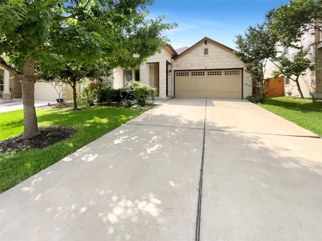 305 Rock Mill Loop, Georgetown, TX 78626 - view of front of house featuring a garage, driveway, a front yard, and stone siding