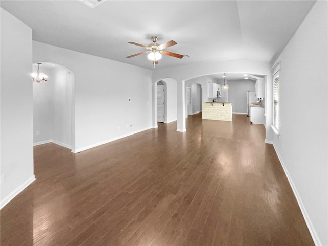 305 Rock Mill Loop, Georgetown, TX 78626 - unfurnished living room with arched walkways, a ceiling fan, dark wood-type flooring, and baseboards