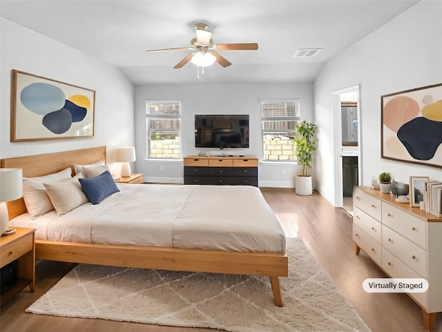 305 Rock Mill Loop, Georgetown, TX 78626 - bedroom featuring wood finished floors, baseboards, ensuite bathroom, and ceiling fan