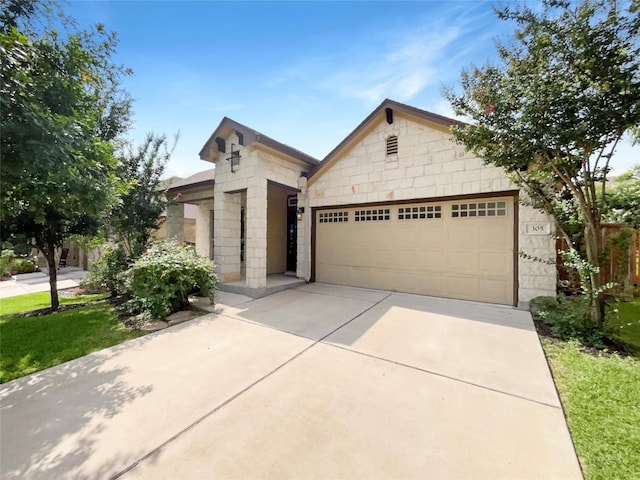 305 Rock Mill Loop, Georgetown, TX 78626 - view of front facade with driveway, a garage, and stone siding