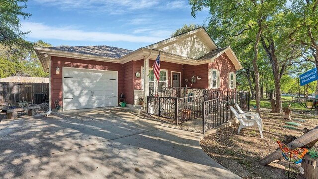 ranch-style home with cooling unit and a garage