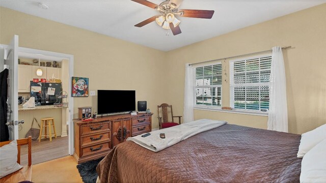 bedroom with freestanding refrigerator and ceiling fan