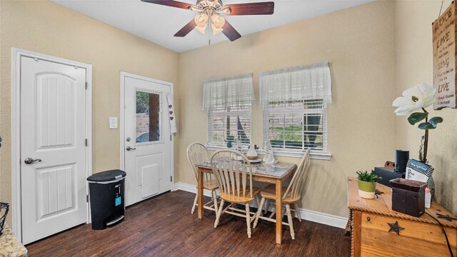 dining room with baseboards, a ceiling fan, and wood finished floors