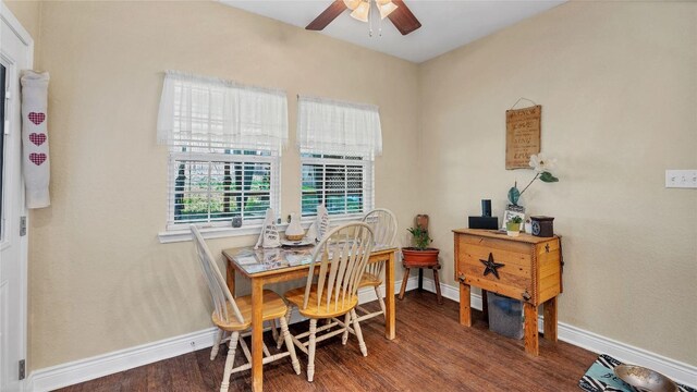 dining area with baseboards, wood finished floors, and a ceiling fan