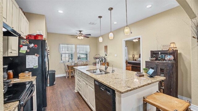 kitchen featuring a ceiling fan, dark wood finished floors, a sink, black appliances, and white cabinets