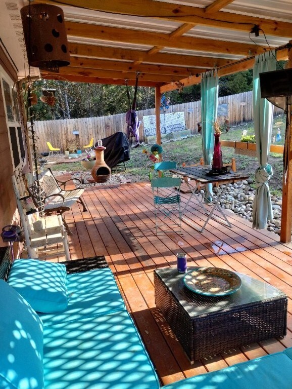 view of patio / terrace with a wooden deck and fence