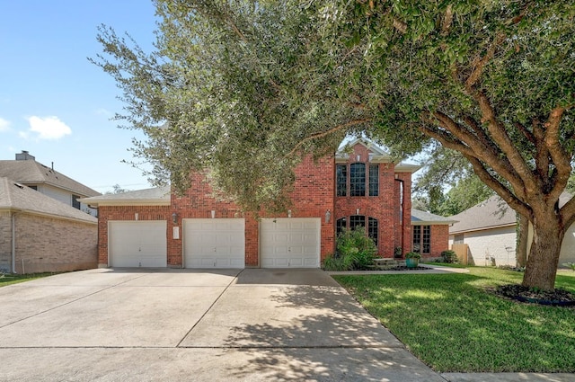 view of front of property with a front yard and a garage