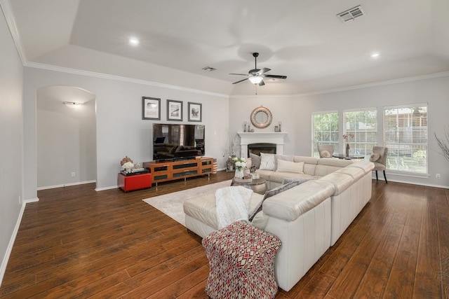 living room featuring dark hardwood / wood-style floors, ceiling fan, and ornamental molding