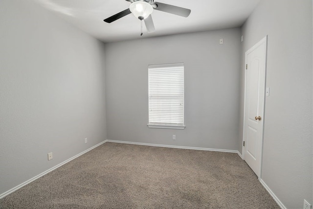 spare room featuring ceiling fan and carpet