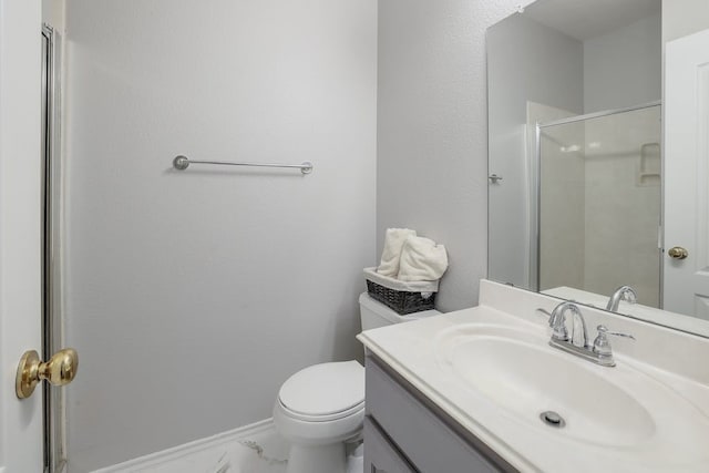 bathroom with vanity, toilet, and walk in shower