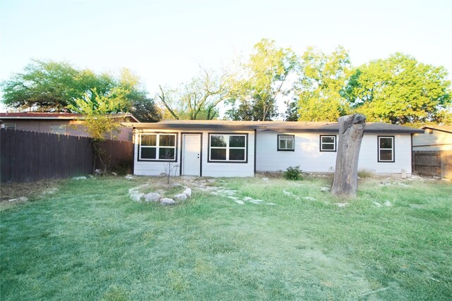 back of house featuring a yard