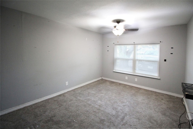 spare room featuring ceiling fan and carpet floors