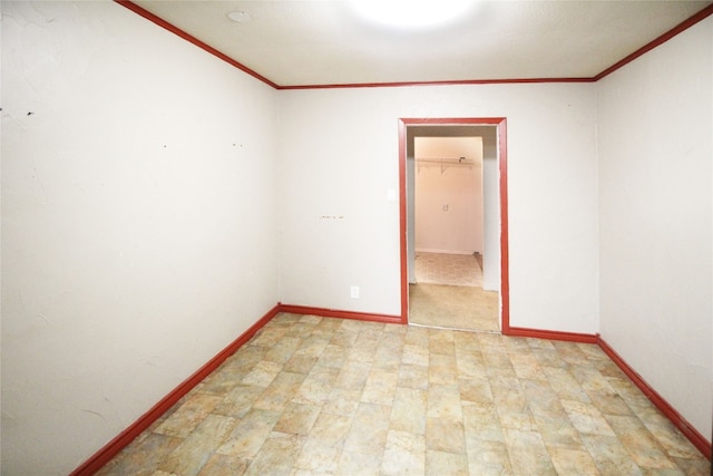 unfurnished room featuring crown molding