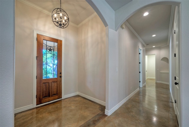 entrance foyer with crown molding and a chandelier