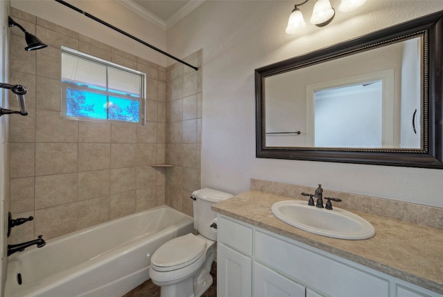 full bathroom featuring ornamental molding, vanity, tiled shower / bath combo, and toilet