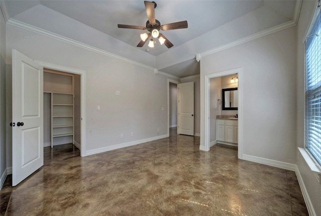 unfurnished bedroom with multiple windows, ceiling fan, a closet, and a raised ceiling