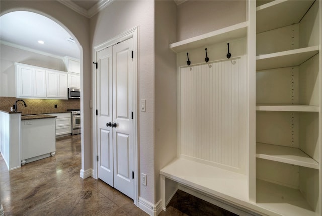 mudroom featuring crown molding and sink