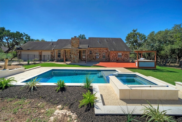 view of pool with a yard, an in ground hot tub, and a patio