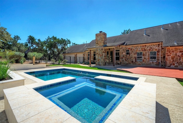 view of swimming pool with an in ground hot tub and a patio area