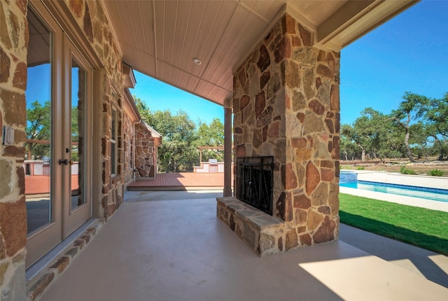 view of patio with an outdoor stone fireplace