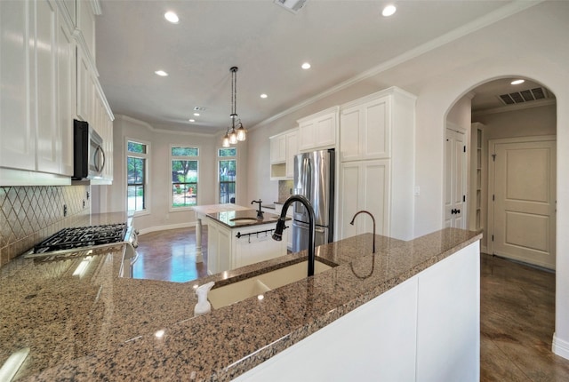 kitchen with dark hardwood / wood-style floors, decorative light fixtures, stainless steel appliances, backsplash, and white cabinets