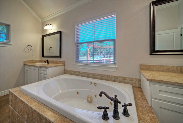 bathroom with tiled tub, vanity, and crown molding