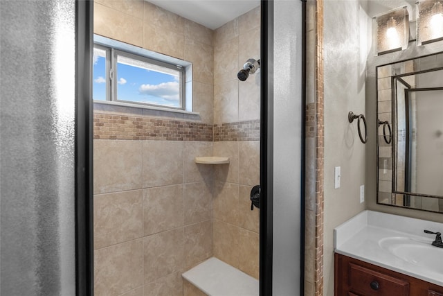 bathroom featuring walk in shower and vanity