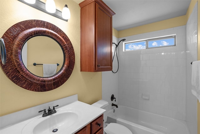 full bathroom with tiled shower / bath, vanity, and toilet