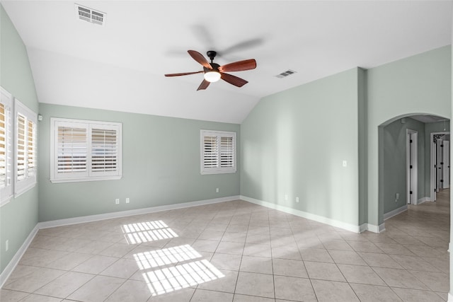 unfurnished room featuring ceiling fan, lofted ceiling, and light tile patterned floors