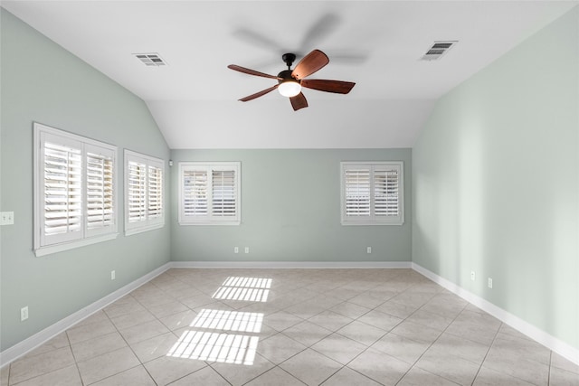 tiled spare room featuring ceiling fan and vaulted ceiling