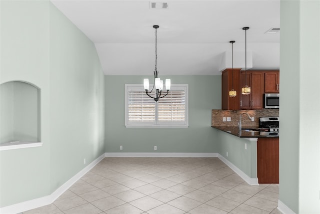 kitchen featuring decorative backsplash, sink, an inviting chandelier, appliances with stainless steel finishes, and decorative light fixtures