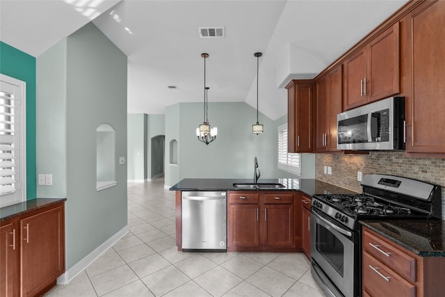 kitchen with kitchen peninsula, sink, vaulted ceiling, and stainless steel appliances