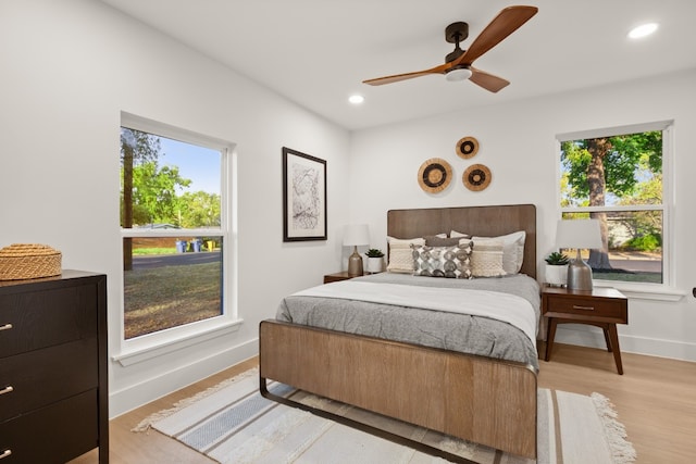 bedroom with ceiling fan and light wood-type flooring